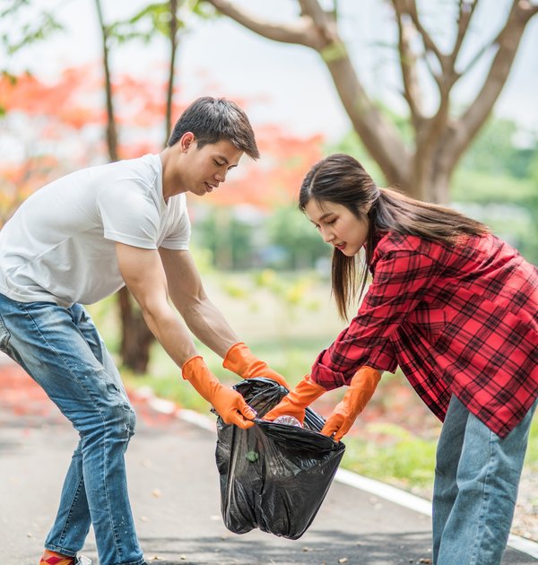men_and_women_help_each_other_to_collect_garbage